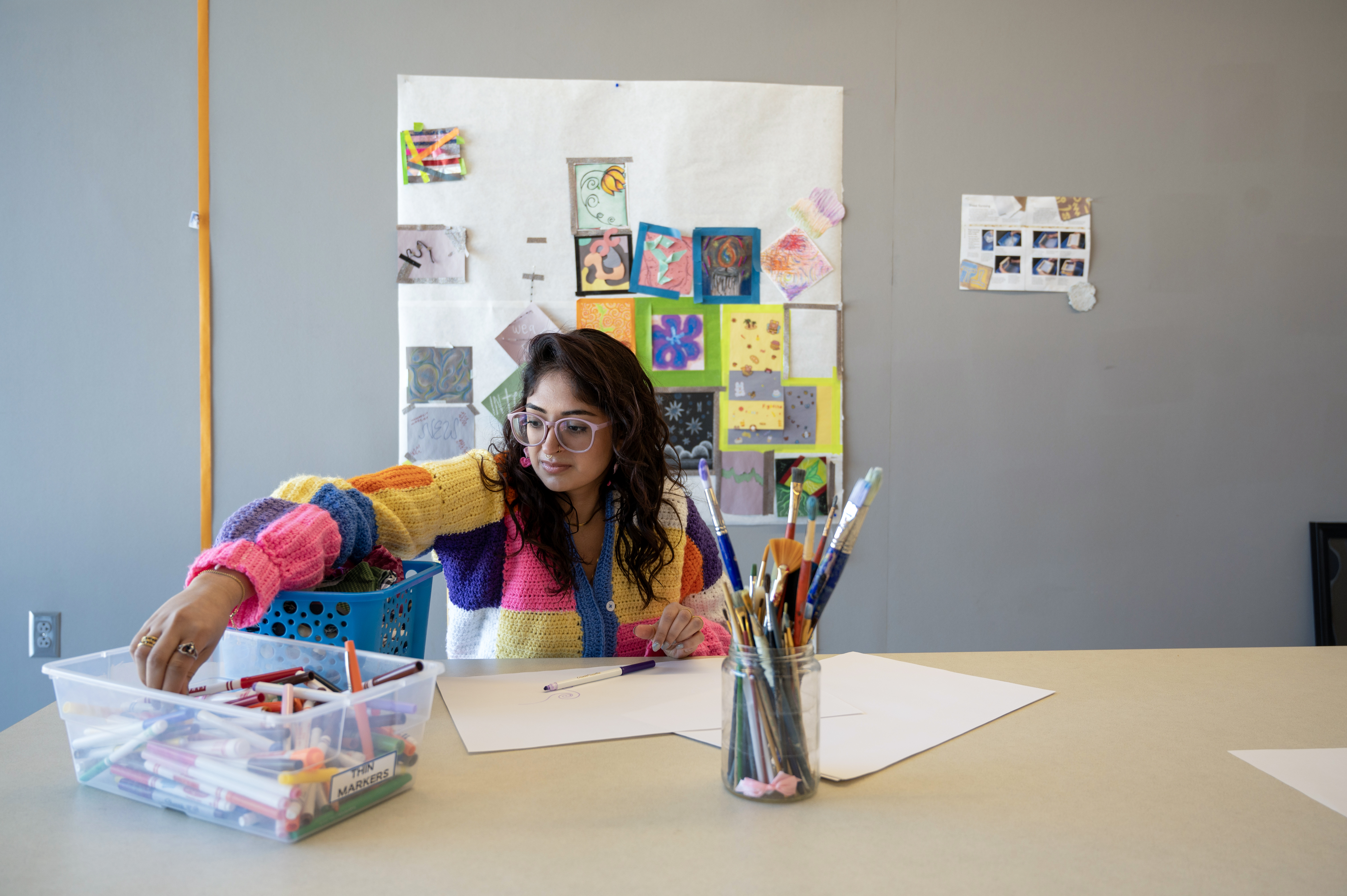 Tara Duggal reaching into art bin